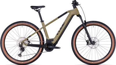 Je ziet een bruine Cube Reaction Hybrid fiets.